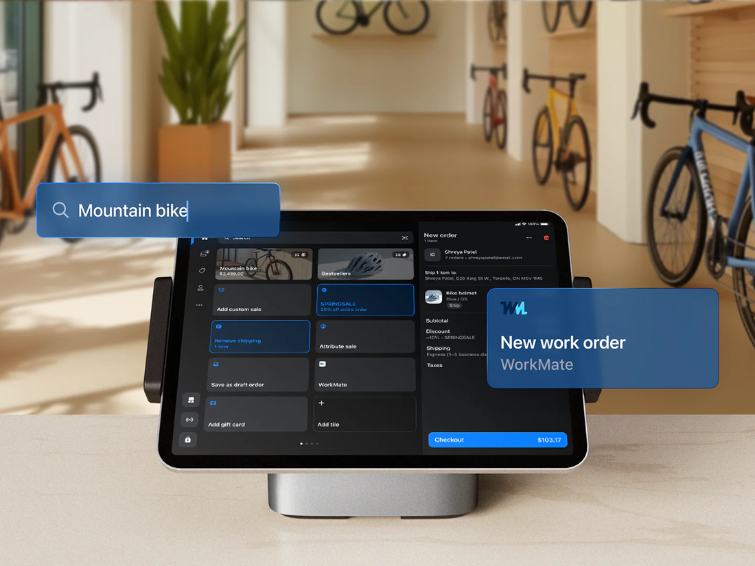 Shopify POS on a bike shop counter with a mountain bike order open and a WorkMate new work order card
